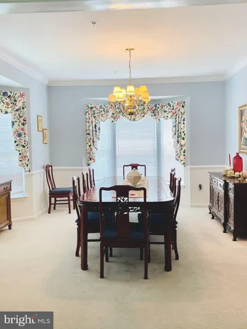 a view of a dining room with furniture and chandelier