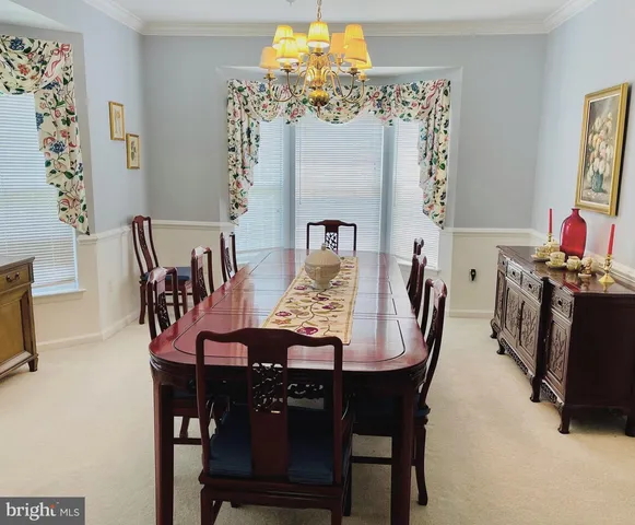 a view of a dining room with furniture and chandelier