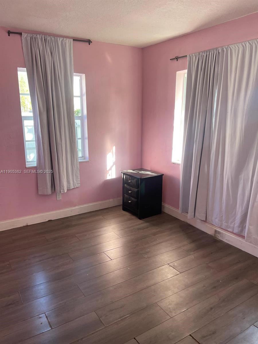 665 Northwest 153rd Street Miami, FL 33169 - Photo 13 of 28 an empty room with wooden floor and windows