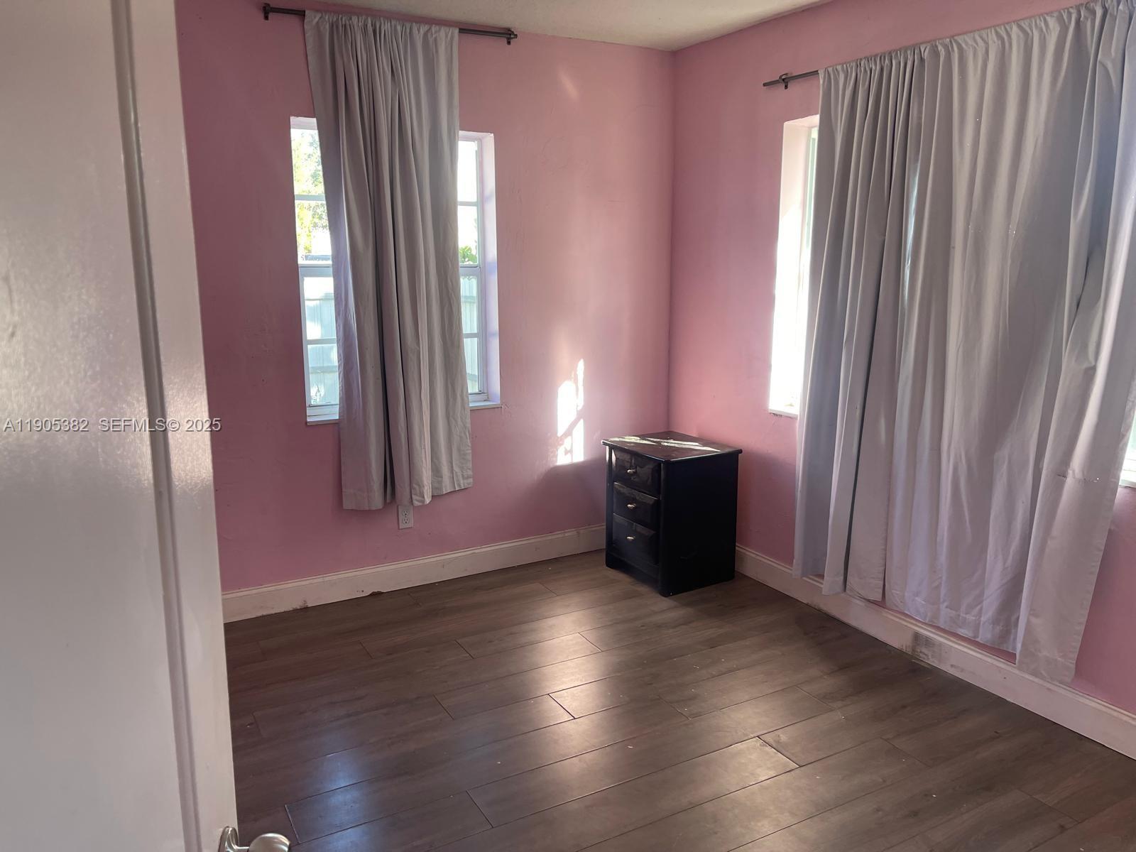 665 Northwest 153rd Street Miami, FL 33169 - Photo 14 of 28 an empty room with wooden floor and windows