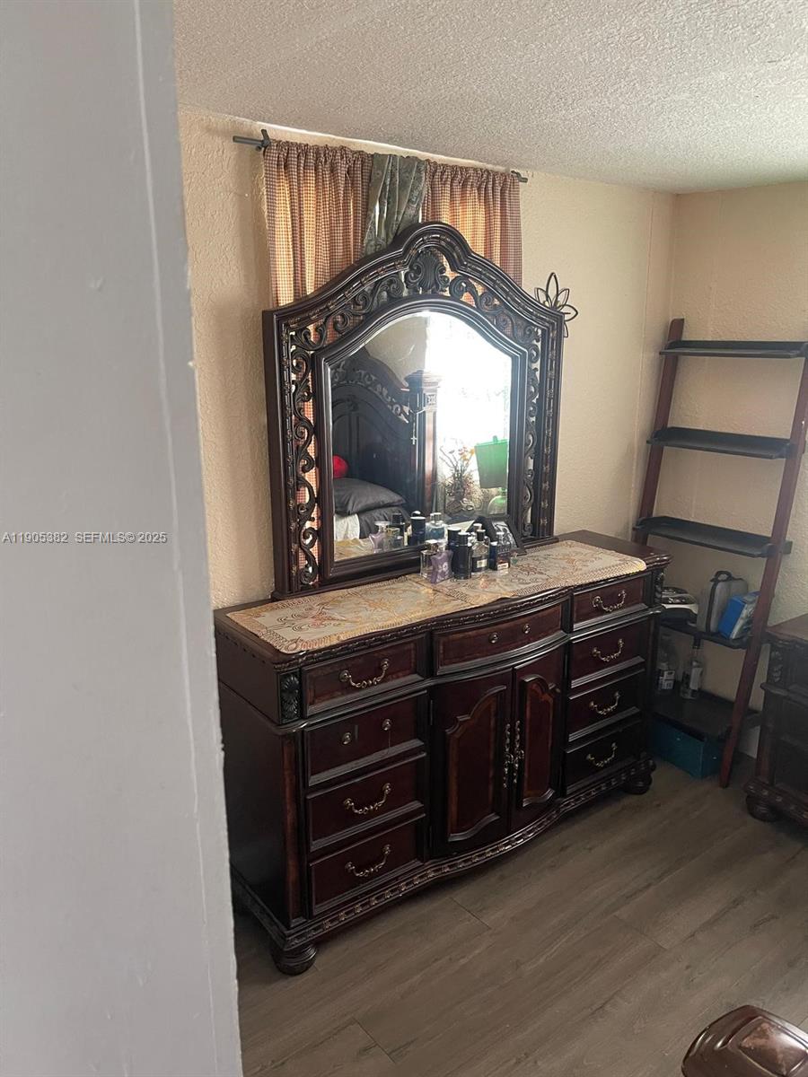 665 Northwest 153rd Street Miami, FL 33169 - Photo 18 of 28 a room with a dresser and a mirror