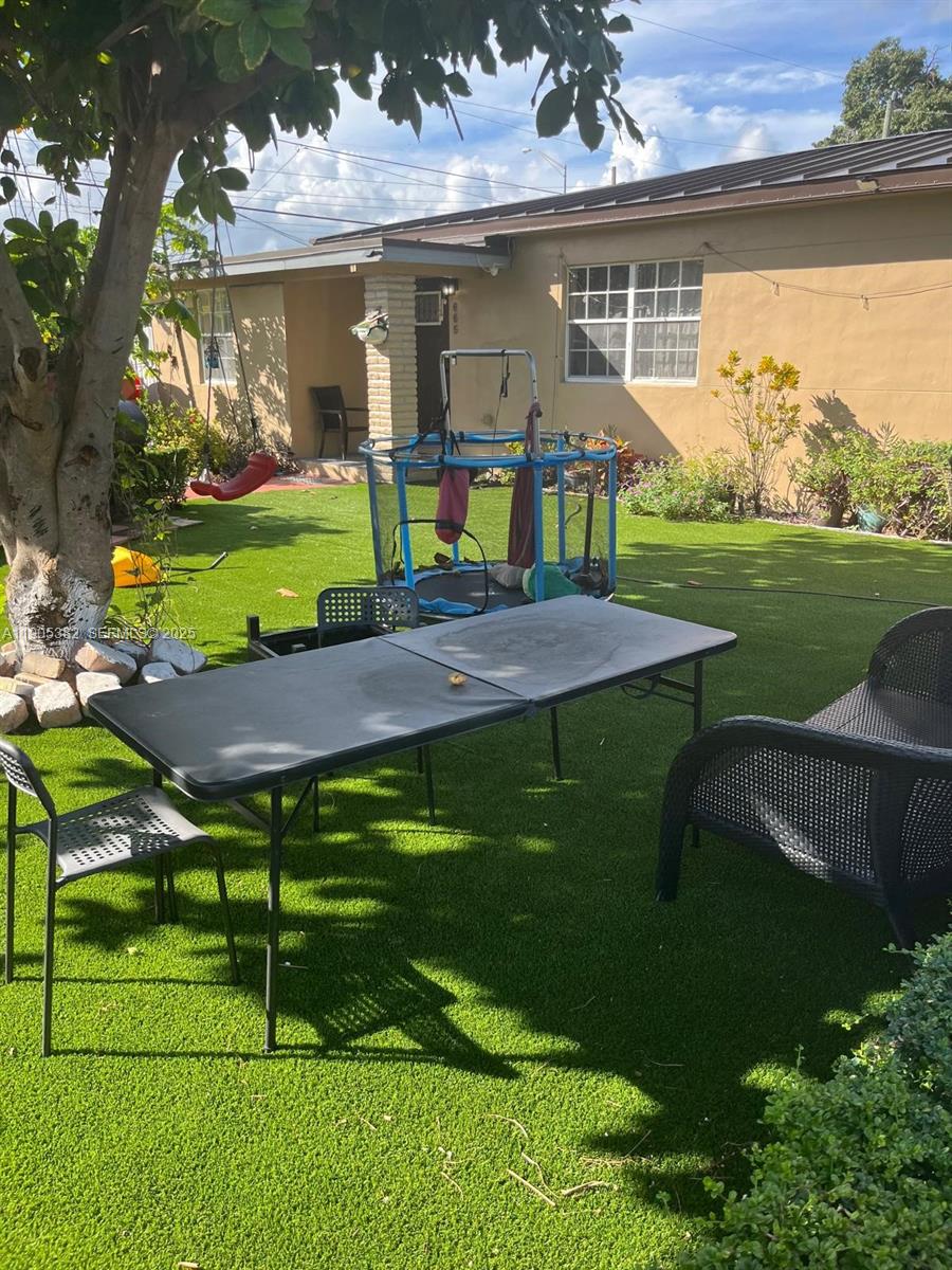 665 Northwest 153rd Street Miami, FL 33169 - Photo 3 of 28 an outdoor space with furniture and garden