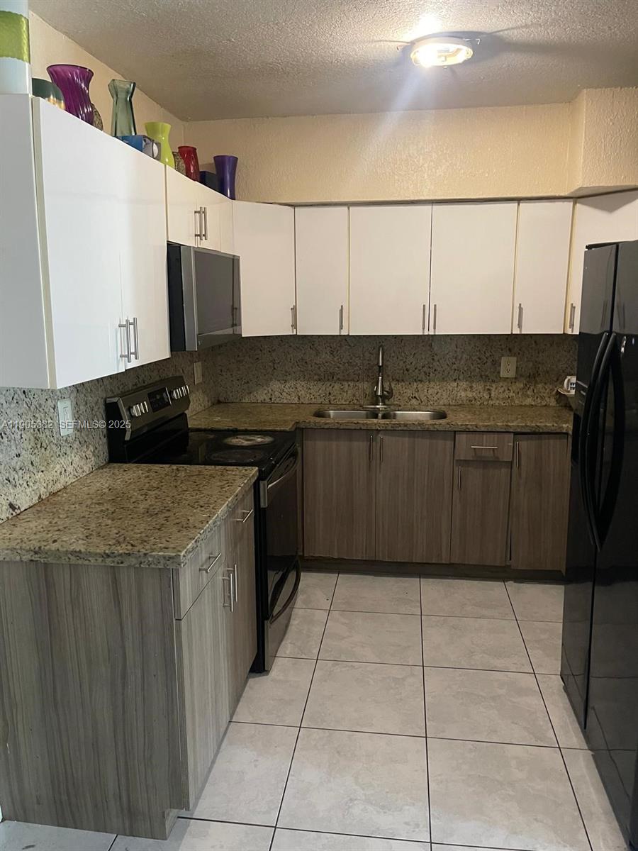 665 Northwest 153rd Street Miami, FL 33169 - Photo 8 of 28 a kitchen with a sink and cabinets