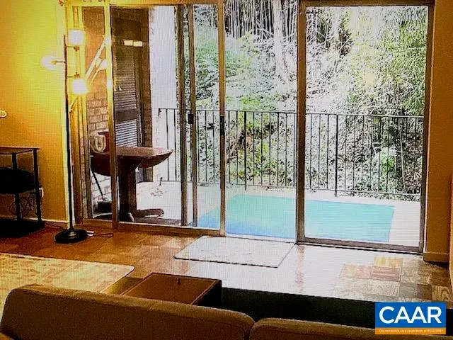 a living room filled with furniture and a floor to ceiling window