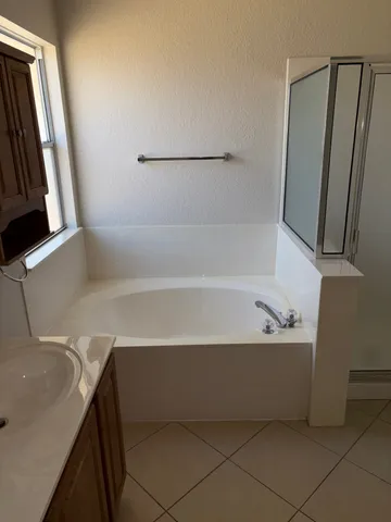 a bathroom with a bathtub and a shower