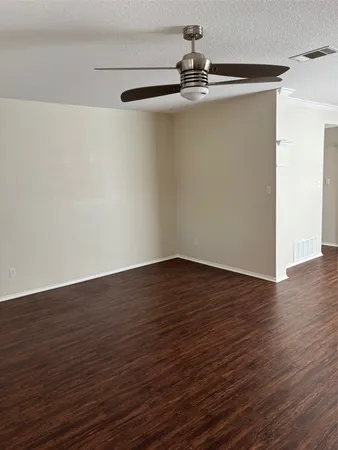 a view of a room with wooden floor