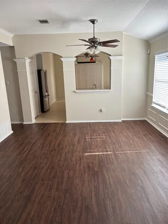 a view of a room with wooden floors and staircase