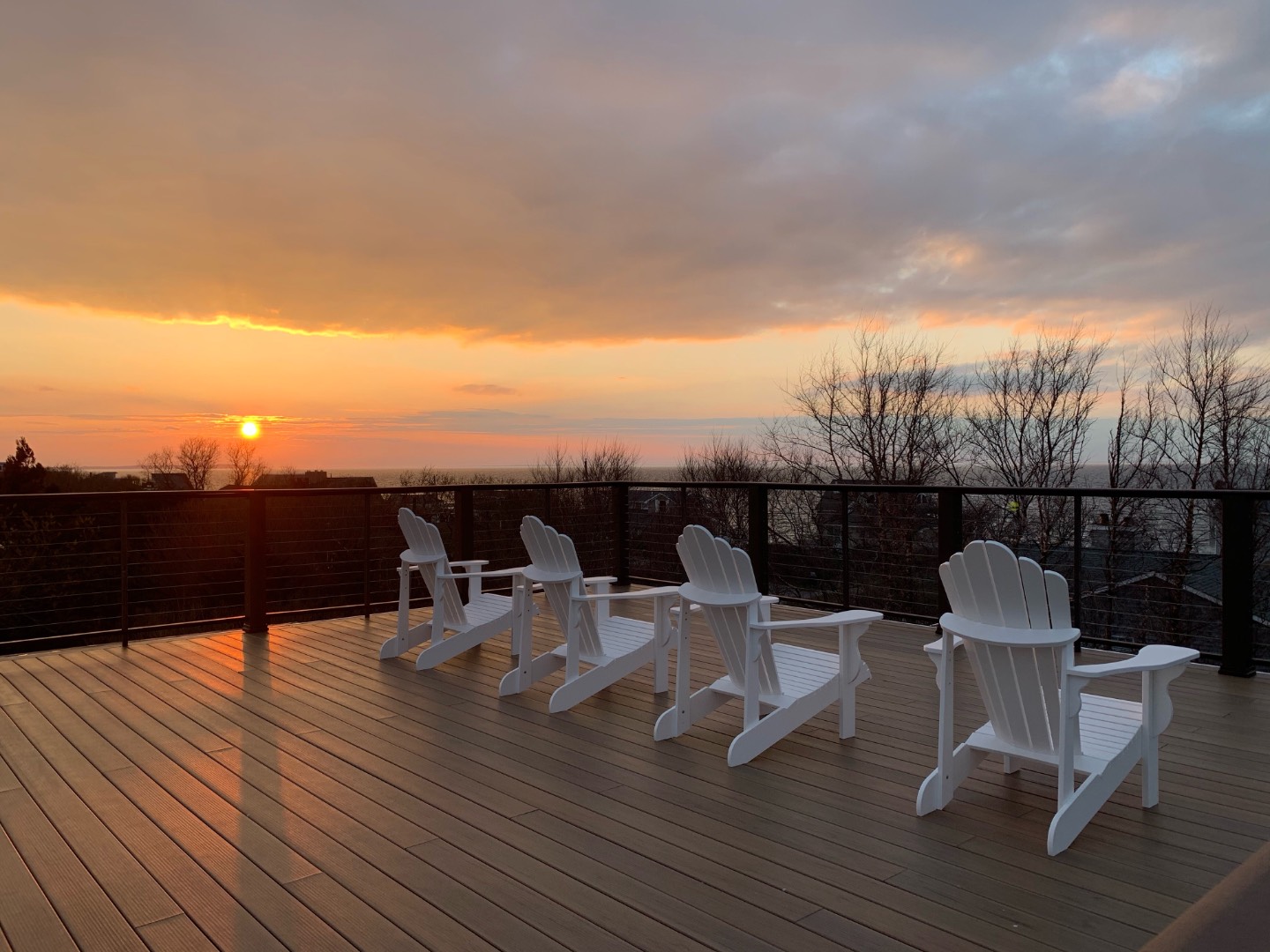 2 Captain Kidds Path Montauk, NY 11954 - Photo 13 of 15 a view of a roof deck with dining table and chairs with wooden floor
