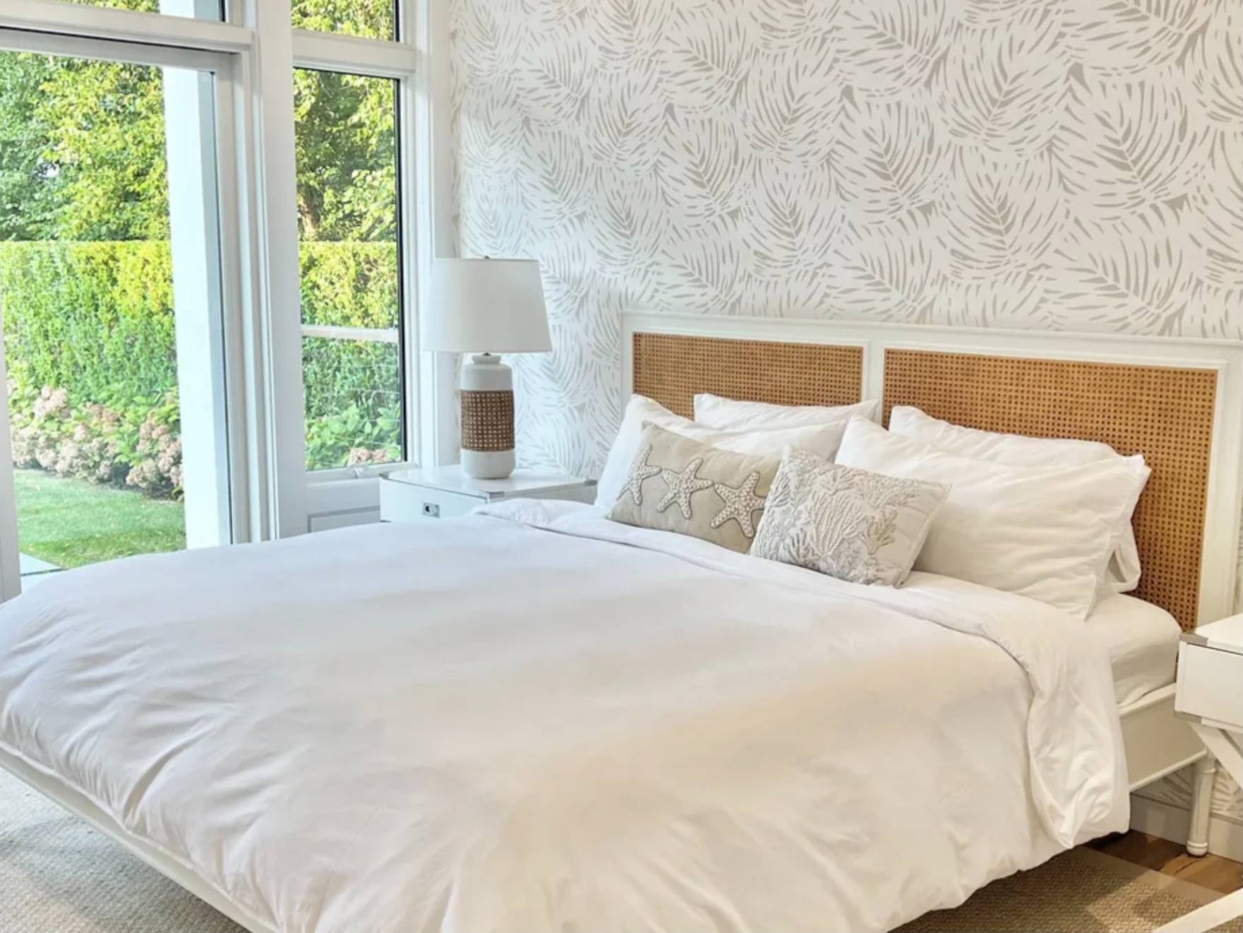 2 Captain Kidds Path Montauk, NY 11954 - Photo 7 of 15 a large white bed in a bedroom next to a window