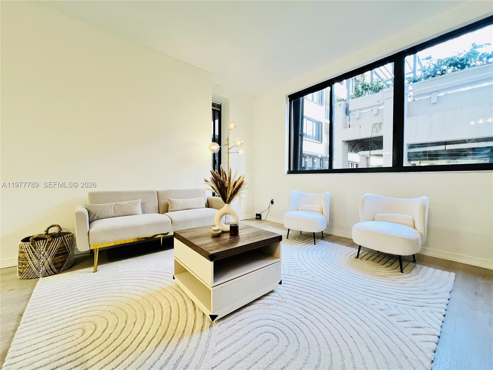 540 Brickell Key Drive, Unit 202 Miami, FL 33131 - Photo 14 of 25 a spacious bedroom with a bed and window