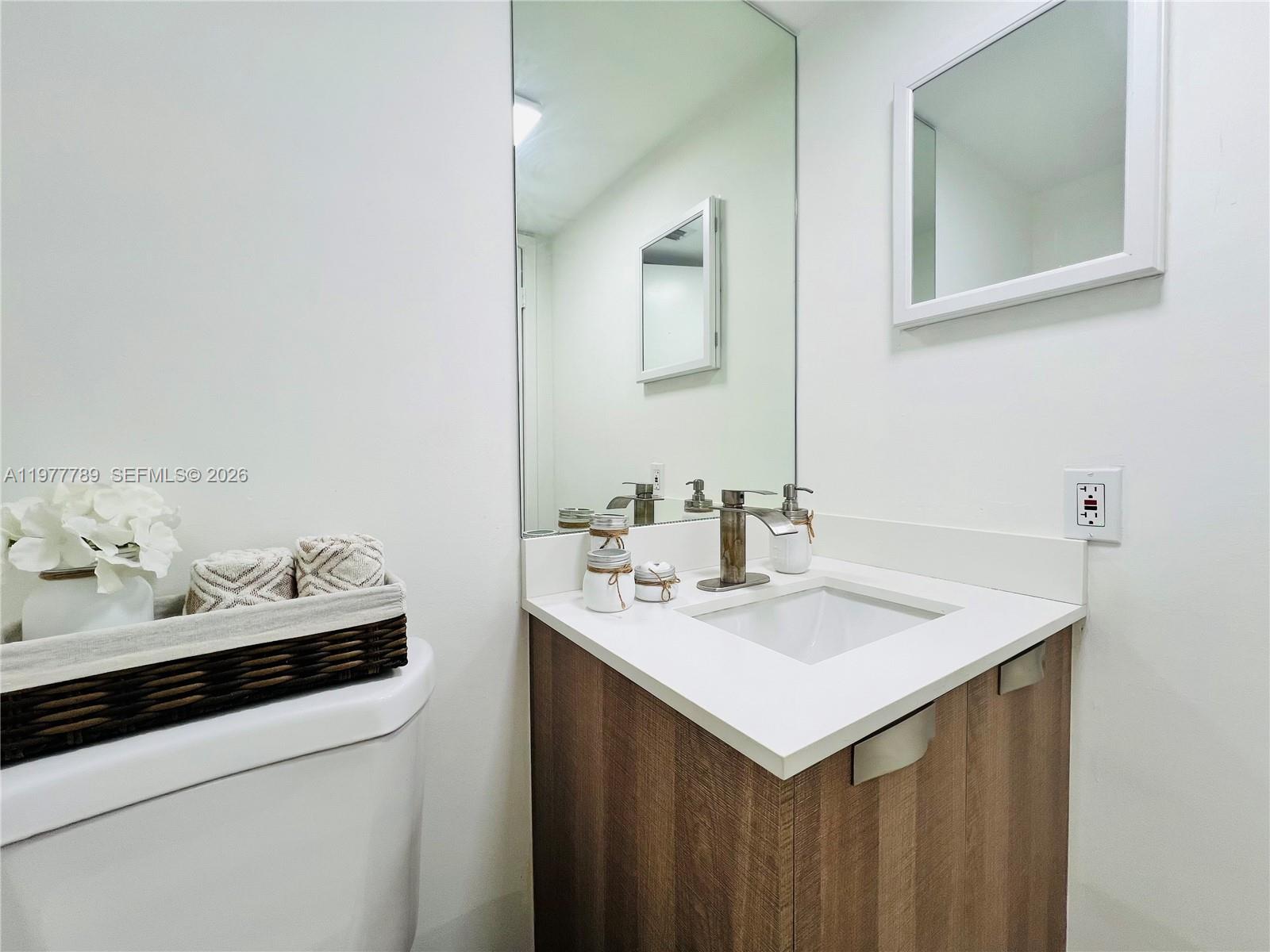 540 Brickell Key Drive, Unit 202 Miami, FL 33131 - Photo 15 of 25 a bathroom with a sink and a mirror