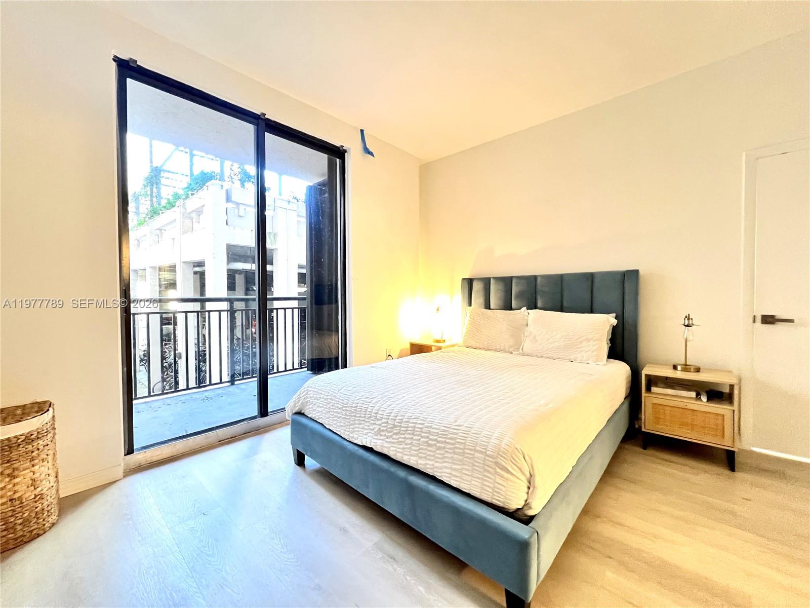 540 Brickell Key Drive, Unit 202 Miami, FL 33131 - Photo 17 of 25 a large bed sitting in a bedroom next to a window