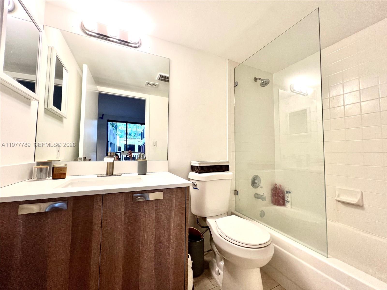 540 Brickell Key Drive, Unit 202 Miami, FL 33131 - Photo 19 of 25 a bathroom with a sink toilet and shower