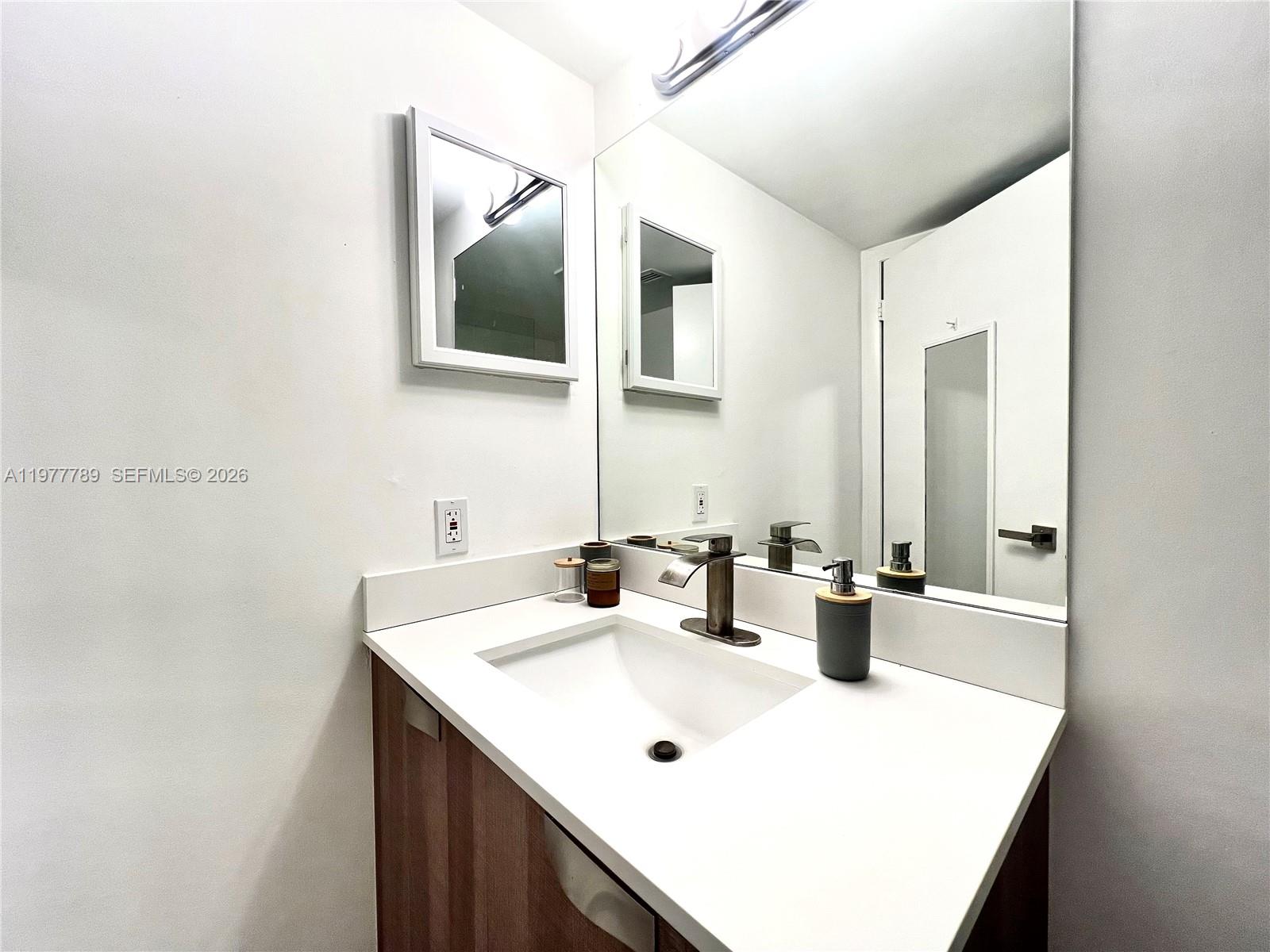 540 Brickell Key Drive, Unit 202 Miami, FL 33131 - Photo 20 of 25 a bathroom with a sink and a mirror