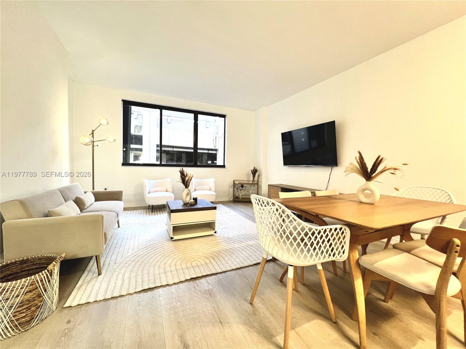 540 Brickell Key Drive, Unit 202 Miami, FL 33131 - Photo 9 of 25 a living room with furniture and a flat screen tv