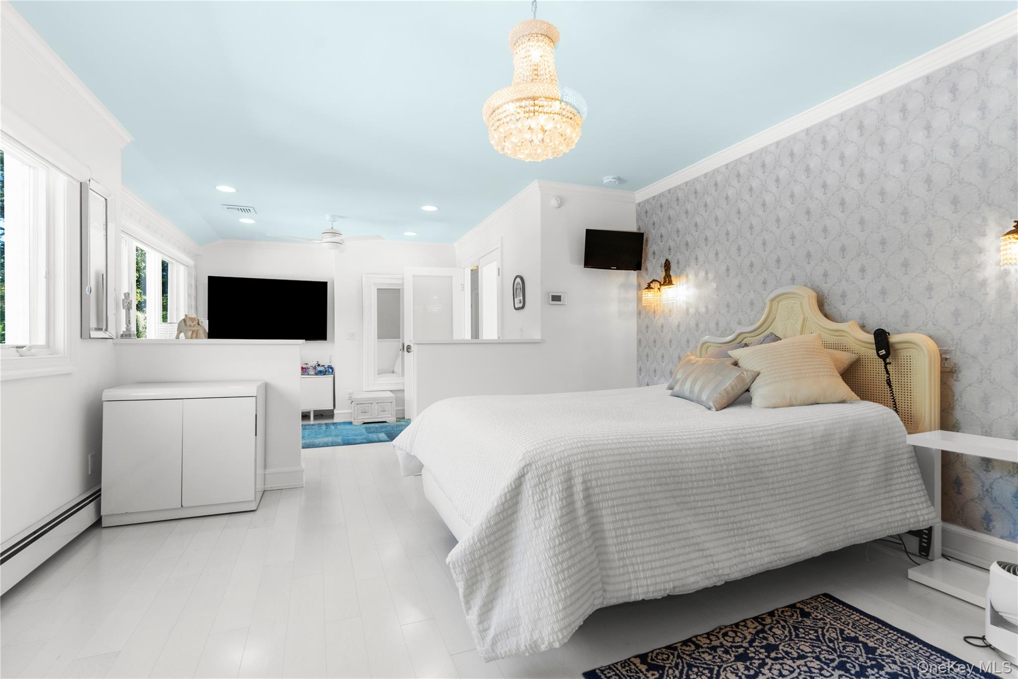 28 Annandale Road Commack, NY 11725 - Photo 13 of 29 Bedroom with crown molding, wallpapered walls, a baseboard heating unit, a chandelier, and recessed lighting