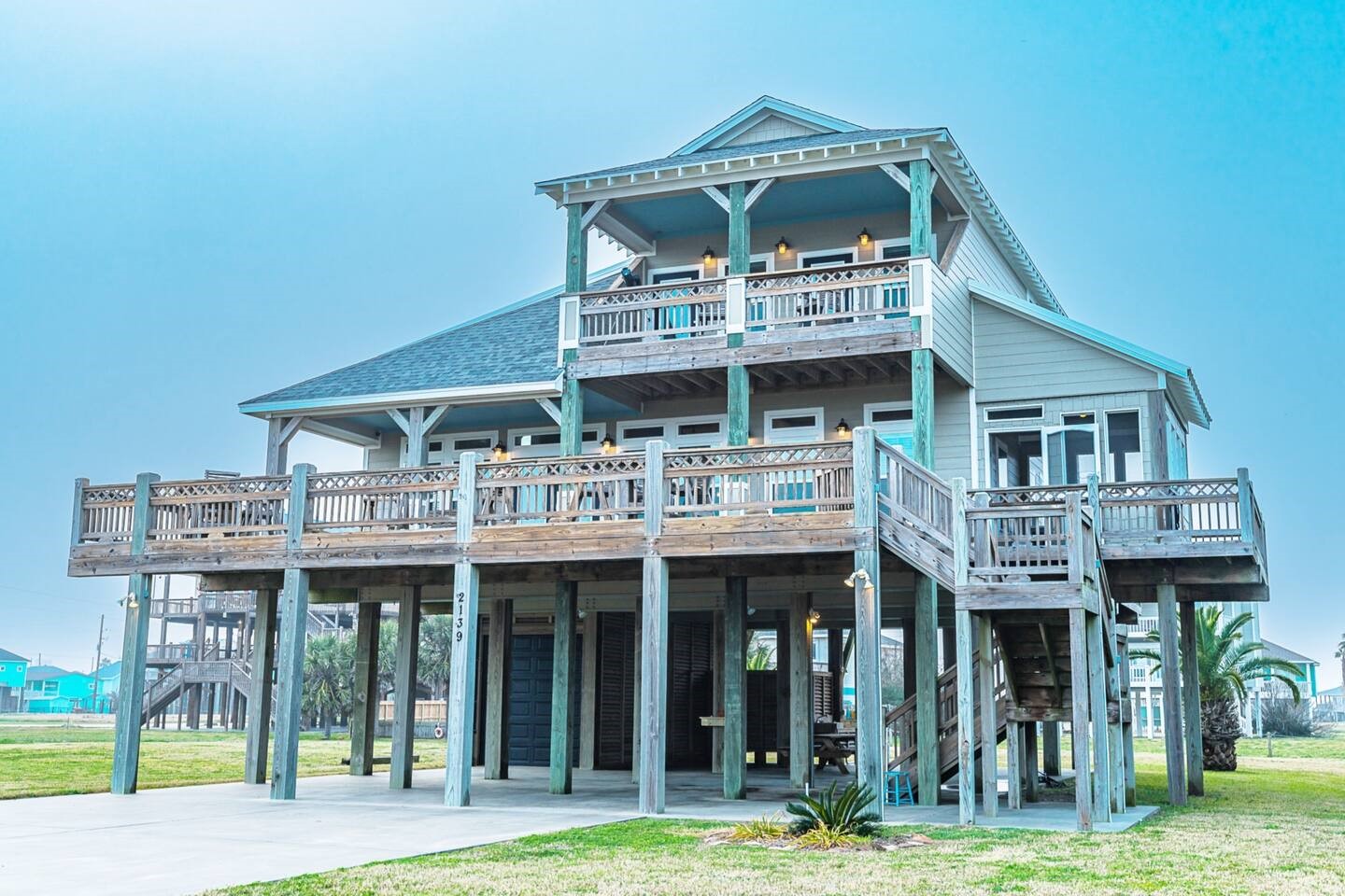 a view of a big building with a small yard and large trees
