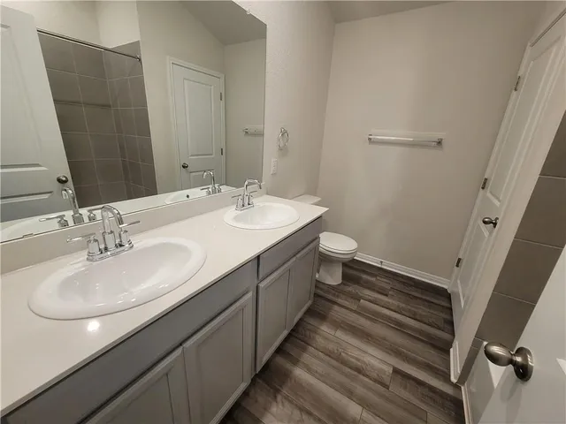 a bathroom with a double vanity sink and a mirror