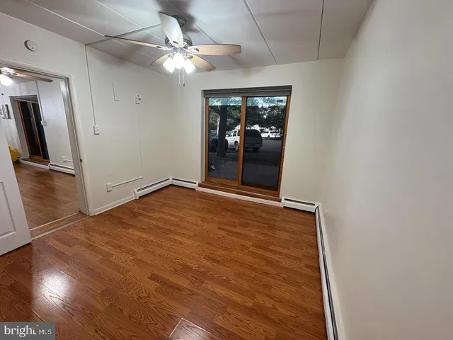wooden floor in an empty room with a window