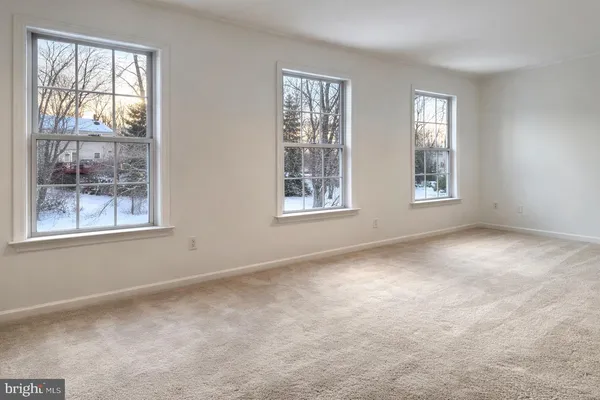 a view of an empty room with windows