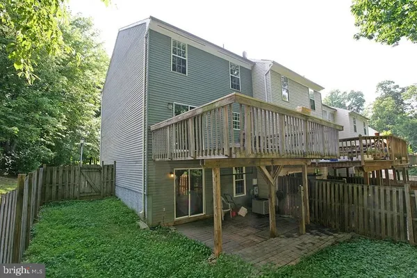 a view of a house with wooden fence