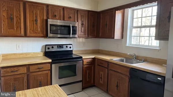 a kitchen with a sink stove and microwave