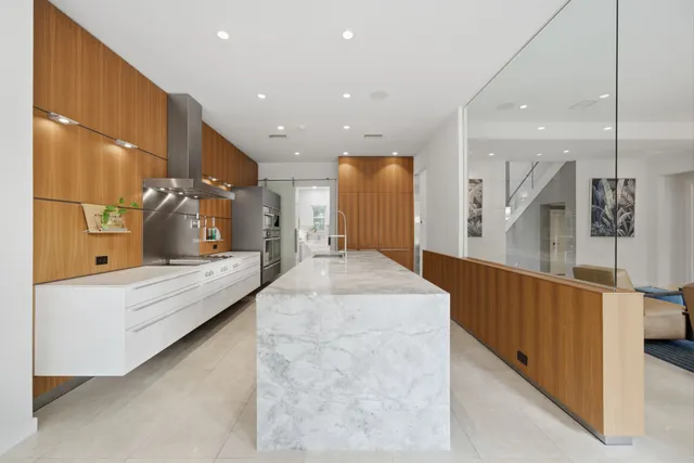 a large bathroom with kitchen island a sink a counter top space and stainless steel appliances