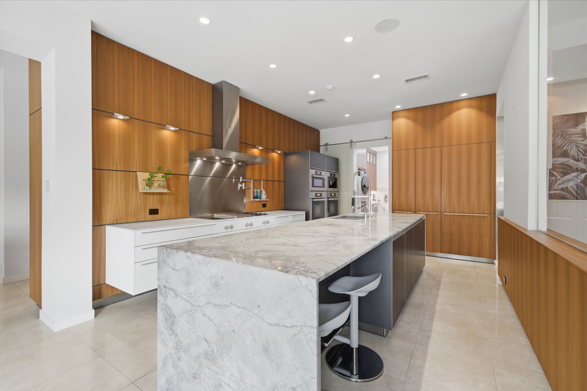3 Farington Way The Woodlands, TX 77382 - Photo 13 of 49 a kitchen with stainless steel appliances kitchen island granite countertop a sink and cabinets