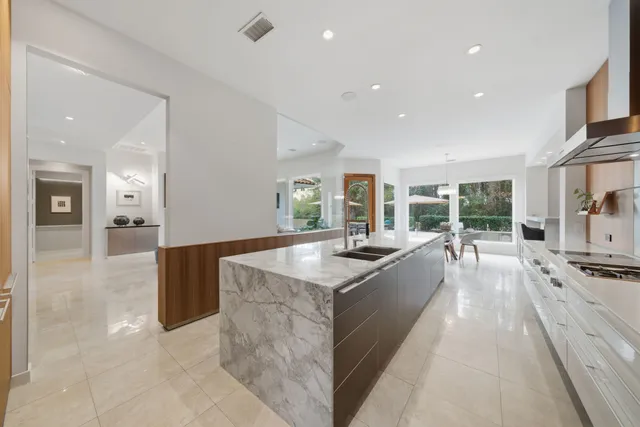 a large kitchen with stainless steel appliances lots of counter top space