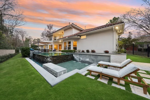 a view of a house with a backyard and sitting area