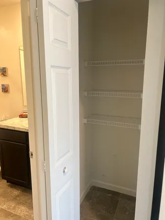 a bathroom with a granite countertop sink toilet a large mirror a shower and a bathtub