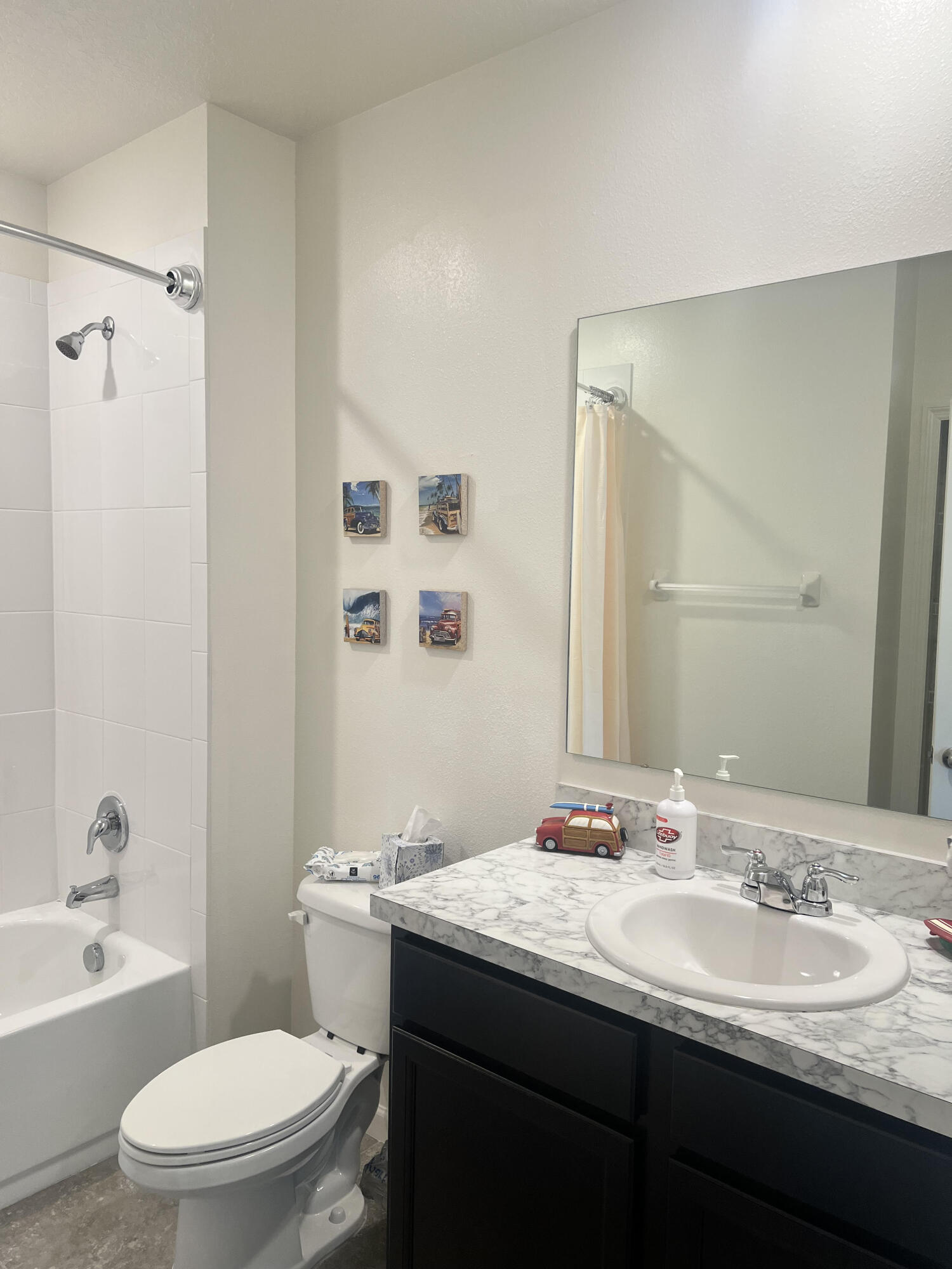 3213 Trinity Circle Fort Pierce, FL 34945 - Photo 15 of 20 a bathroom with a granite countertop sink toilet a large mirror a shower and a bathtub