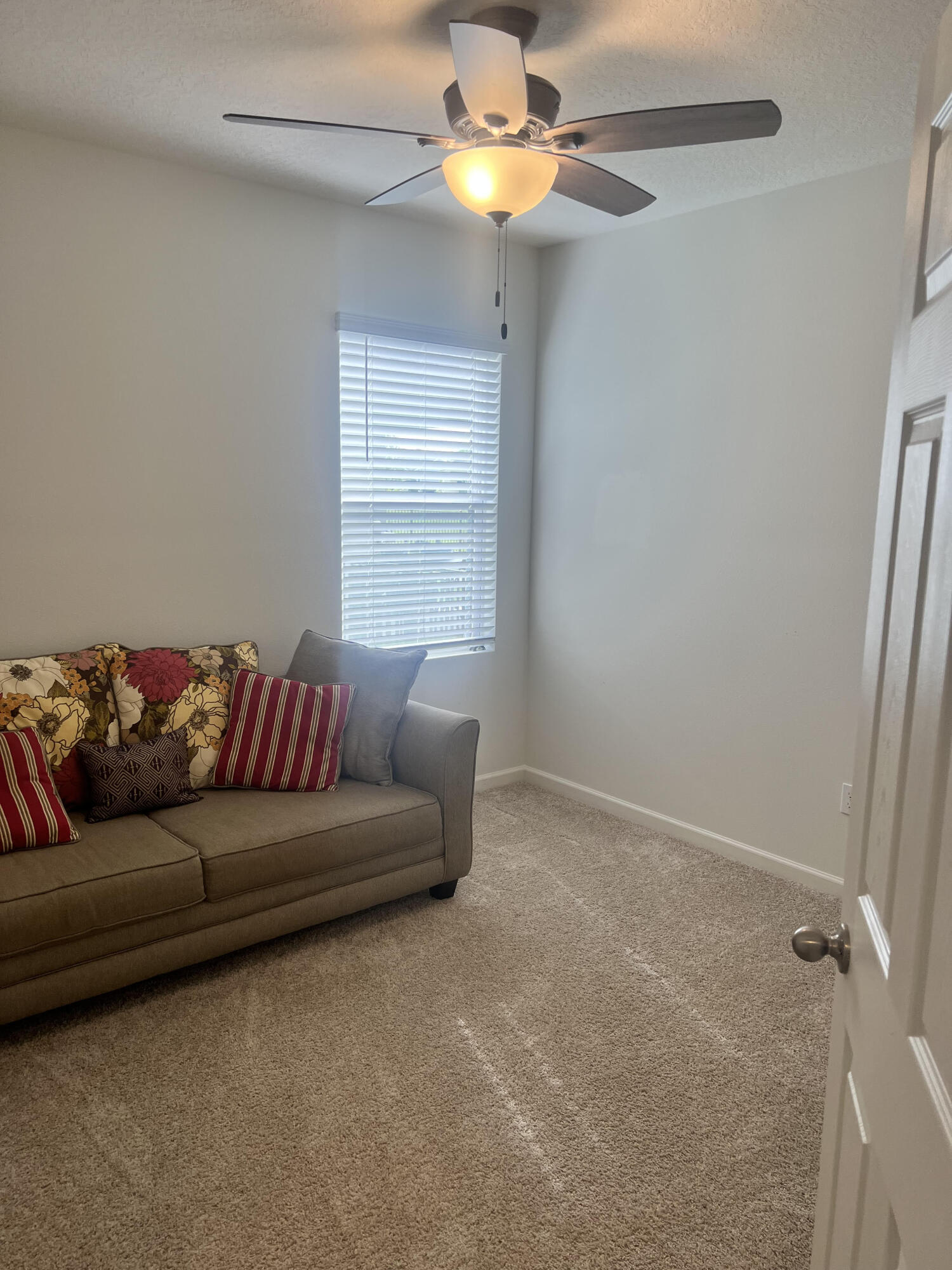 3213 Trinity Circle Fort Pierce, FL 34945 - Photo 17 of 20 a living room with furniture and a chandelier