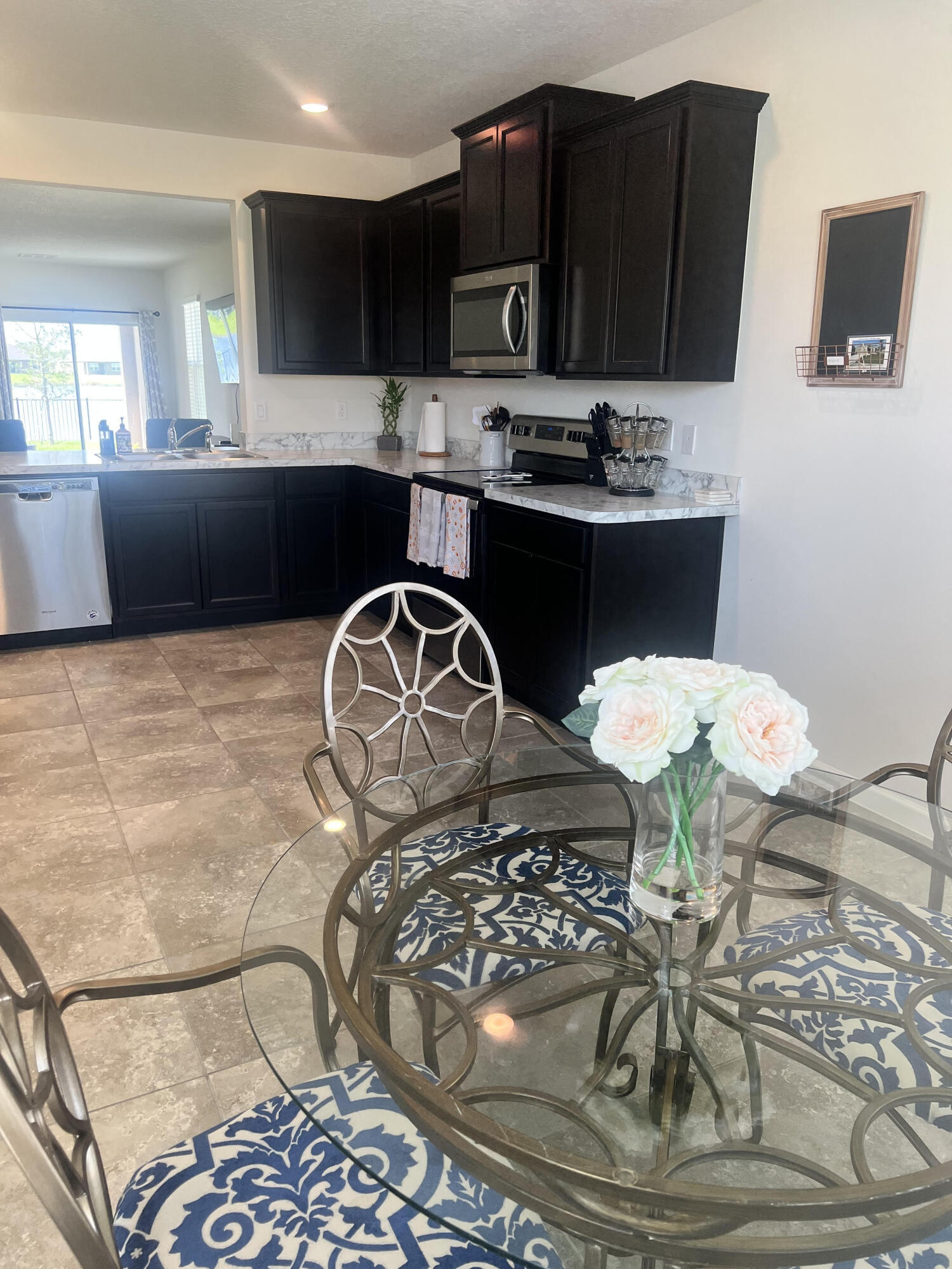 3213 Trinity Circle Fort Pierce, FL 34945 - Photo 4 of 20 a kitchen with a sink and cabinets