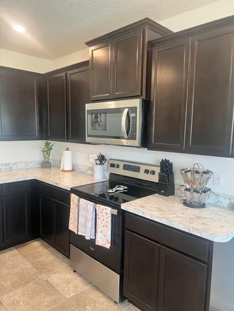 a kitchen with stainless steel appliances granite countertop a sink stove and cabinets