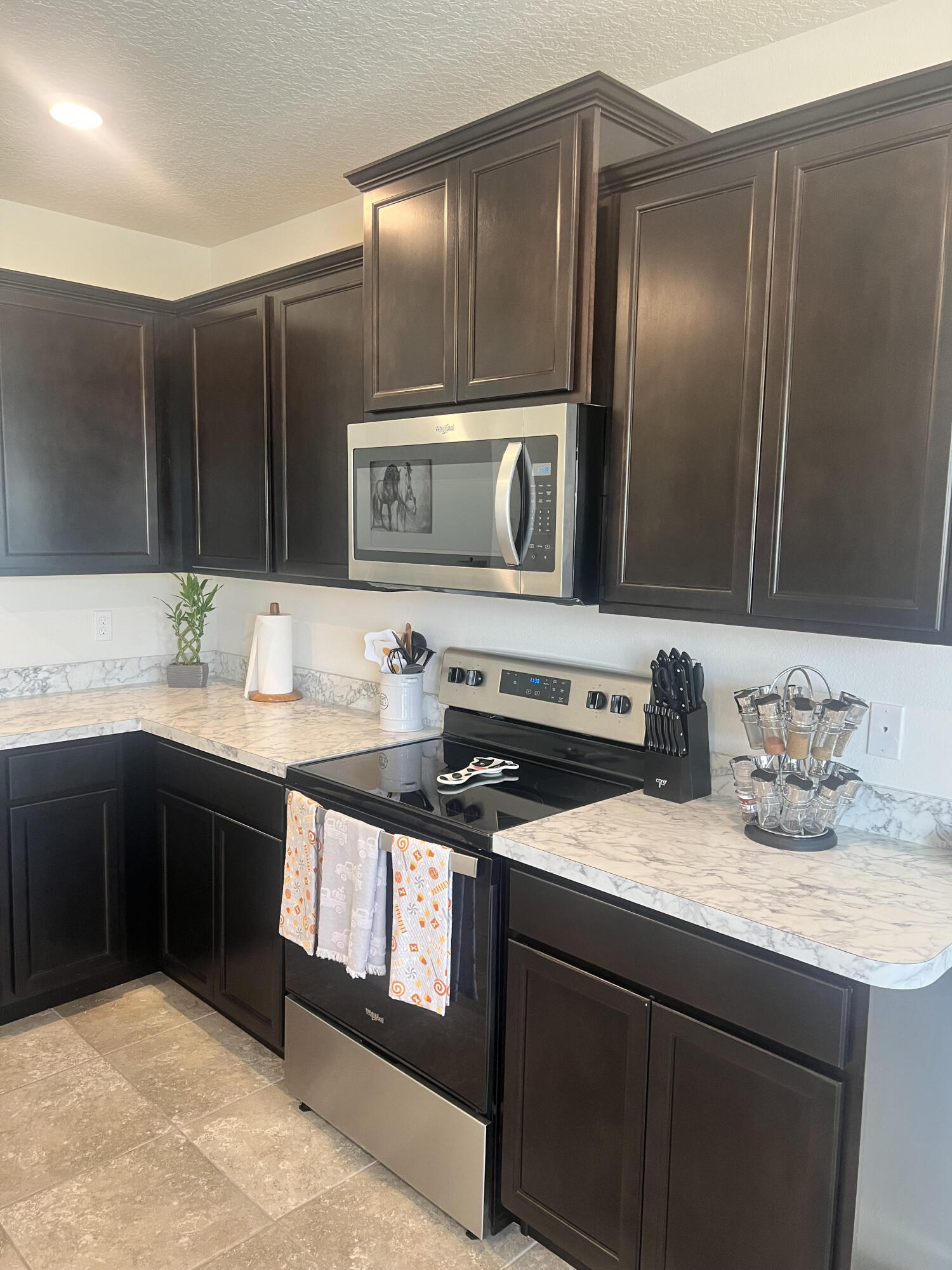3213 Trinity Circle Fort Pierce, FL 34945 - Photo 6 of 20 a kitchen with stainless steel appliances granite countertop a sink stove and cabinets
