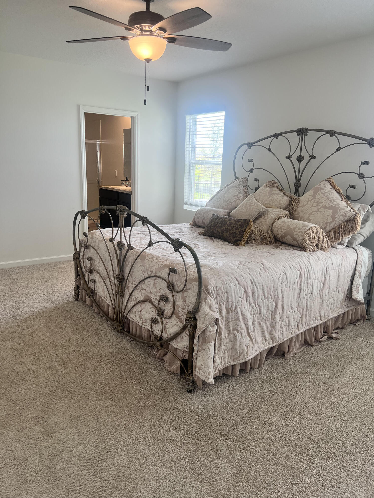 3213 Trinity Circle Fort Pierce, FL 34945 - Photo 9 of 20 a bedroom with a bed and a chandelier