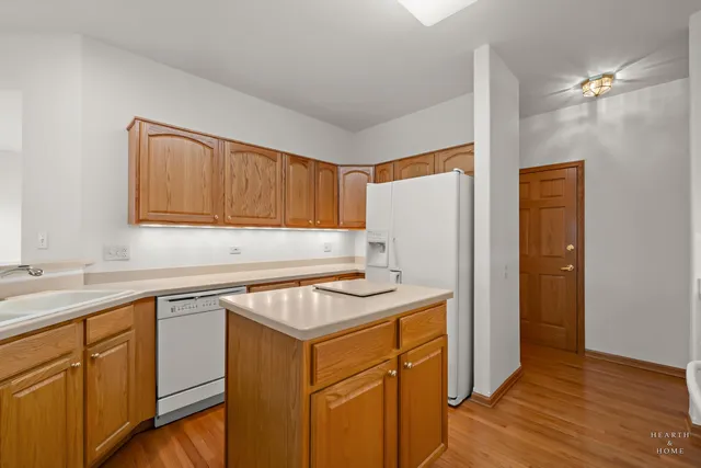 a kitchen with a sink stove and refrigerator
