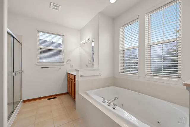 a bathroom with a bathtub sink and window