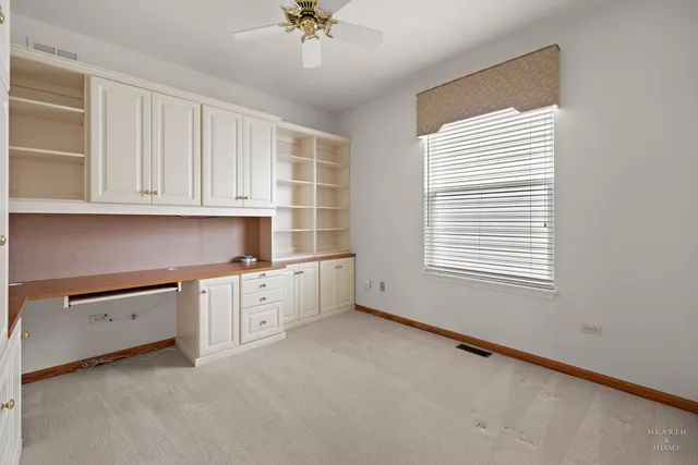 a kitchen with granite countertop white cabinets and window