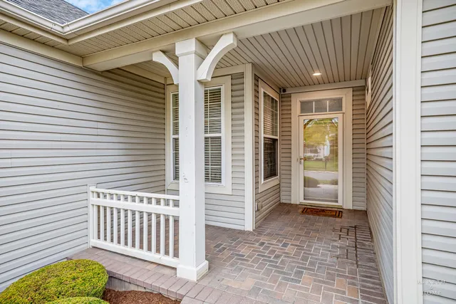 a view of a porch with a table and chairs