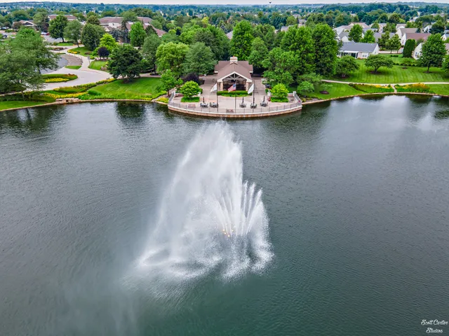 a view of a lake with a house swimming pool and outdoor space