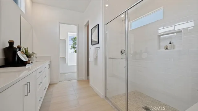 a bathroom with a shower and a sink