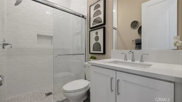 a bathroom with a granite countertop sink toilet and shower