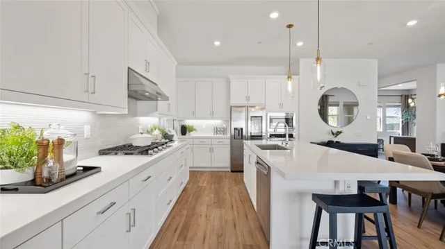 a large kitchen with a table and chairs in it