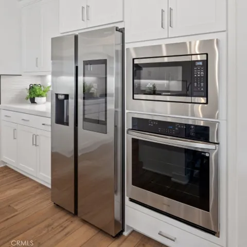 a kitchen with cabinets and stainless steel appliances