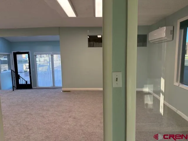 a view of an empty room and glass door