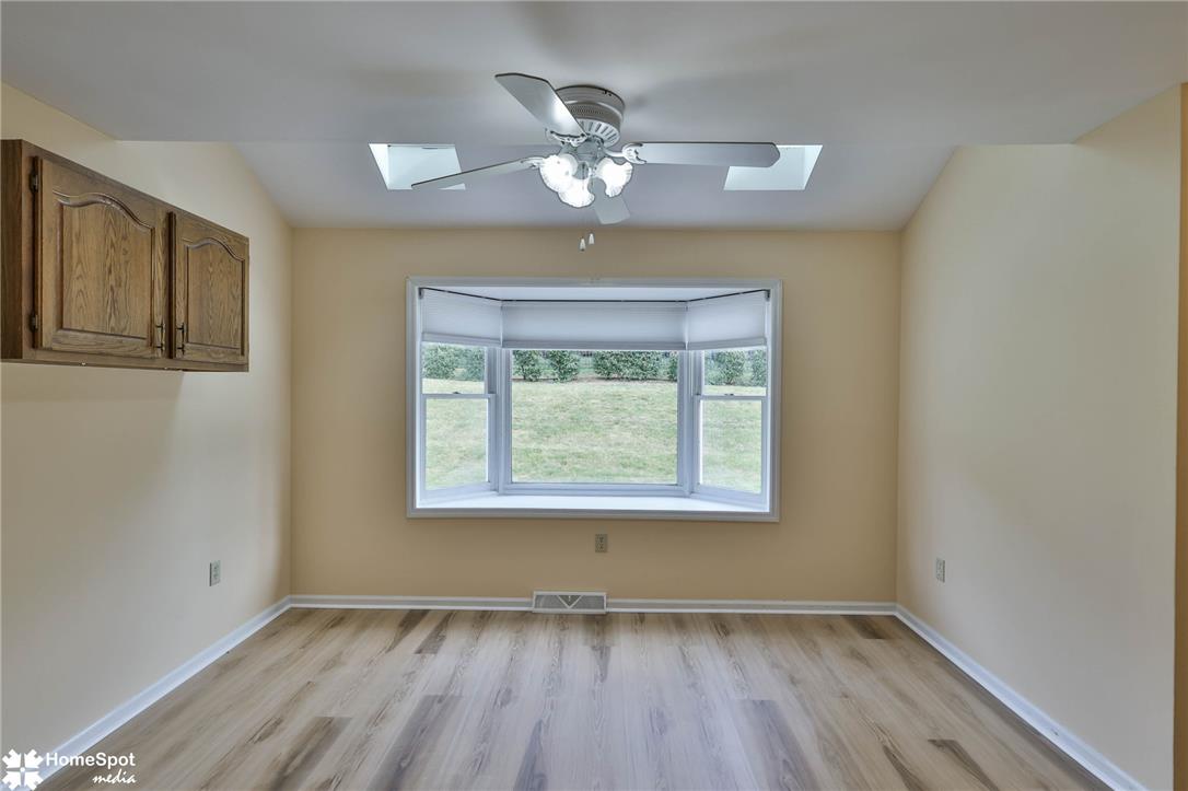 4059 Wedgewood Road Allentown, PA 18104 - Photo 13 of 72 A well-lit room featuring a charming bay window and functional ceiling fan.