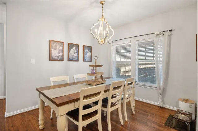 a view of a dining room with furniture wooden floor and chandelier