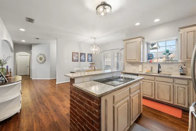 a kitchen with stainless steel appliances granite countertop a stove and a sink